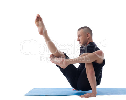 Young flexible yogi posing in complicated asana