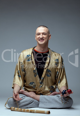 Studio shot of smiling man doing yoga