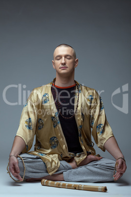 Image of yoga guru meditates in studio