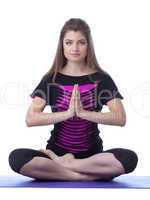 Studio shot of beautiful brunette practicing yoga