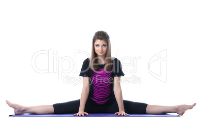 Flexible pretty girl stretched on yoga mat