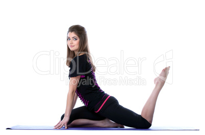 Studio shot of beautiful sporty girl posing on mat