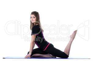 Studio shot of beautiful sporty girl posing on mat