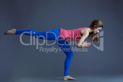 Studio shot of pretty woman doing yoga exercises