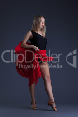 Pretty sensual woman dancing with red cloth
