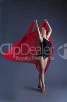 Graceful young girl dancing with red chiffon