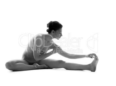 Black and white image of naked woman doing yoga