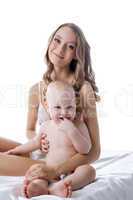 Studio shot of pretty young woman and her child