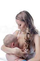 Portrait of happy mother breast-feeds her baby