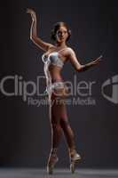 Pretty contemporary ballet dancer posing in studio