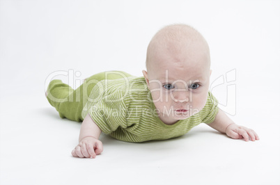 pensive toddler in green clothing