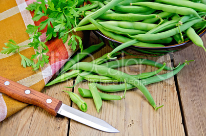 Beans green on board with knife and napkin