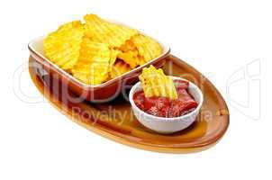 Chips in tomato sauce on a clay plate