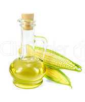 Corn oil in a carafe with two cobs