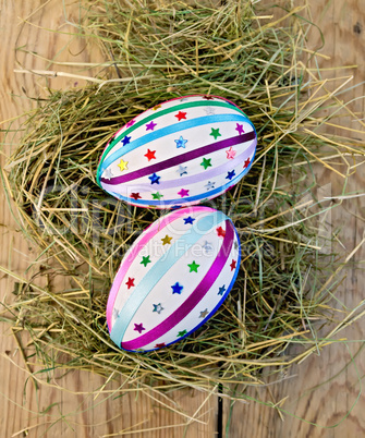 Easter eggs with ribbons and sequins on board