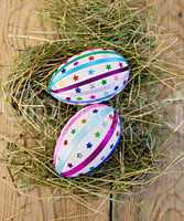 Easter eggs with ribbons and sequins on board