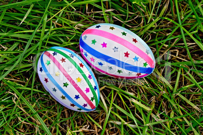 Easter eggs with ribbons and sequins on grass
