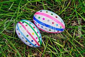 Easter eggs with ribbons and sequins on grass