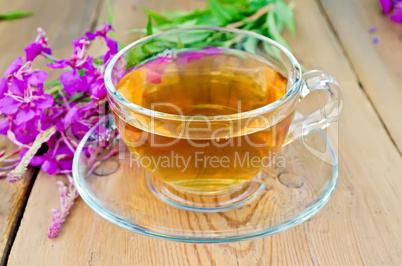 Herbal tea in glass cup of fireweed on board