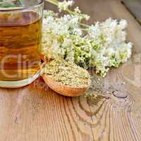 Herbal tea of meadowsweet dried in spoon and mug