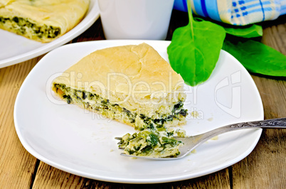 pie spinach and cheese with fork on board