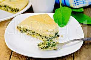pie spinach and cheese with fork on board