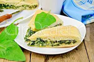 pie spinach and cheese with leaves and knife
