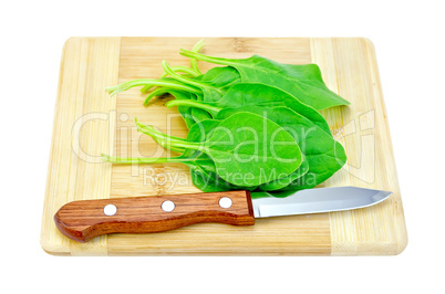 Spinach on the board with a knife