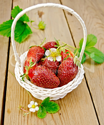 Strawberries in basket with flowers on board