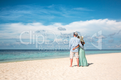 vacation couple walking on tropical beach maldives.