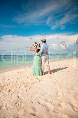 vacation couple walking on tropical beach maldives.