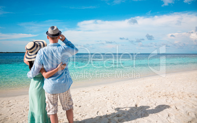 vacation couple walking on tropical beach maldives.