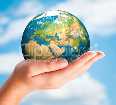 hand of the person holds globe.