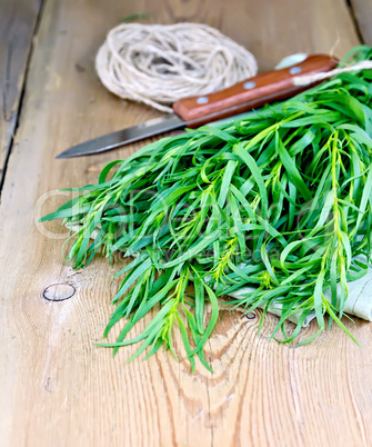Tarragon with knife and napkin on board
