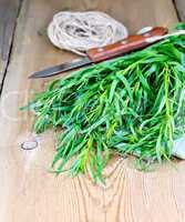 Tarragon with knife and napkin on board