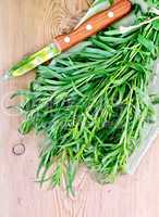 Tarragon with a knife on board