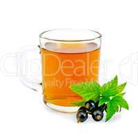 Tea with black currant in glass mug