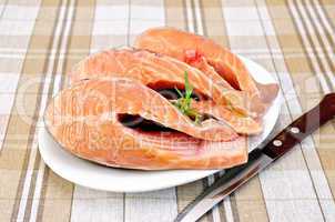 Trout in plate with rosemary on napkin
