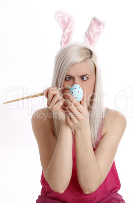 woman paints easter egg
