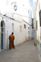 moroccan walking through narrow alley