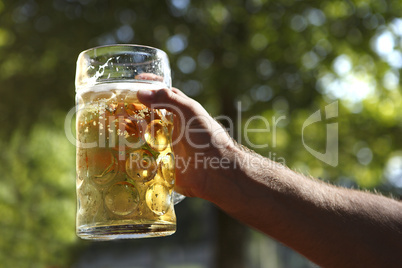 man holds beer in hand