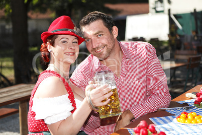 couple in traditional costume in a beer garden