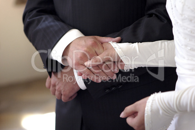 Hands of a bride and groom