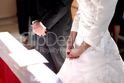 Hands of a bride and groom