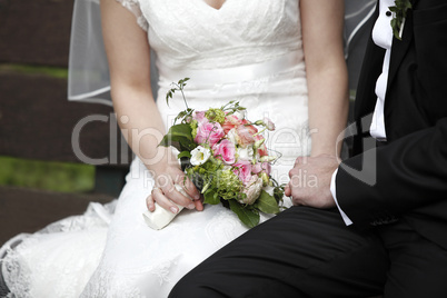 Hands of a bride and groom