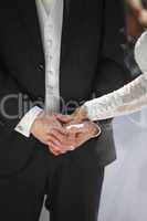 Hands of a bride and groom