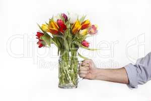 A hand full of colorful tulips
