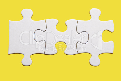 White puzzle piece on yellow background