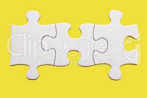 White puzzle piece on yellow background