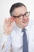 man holding his ear to hear better
